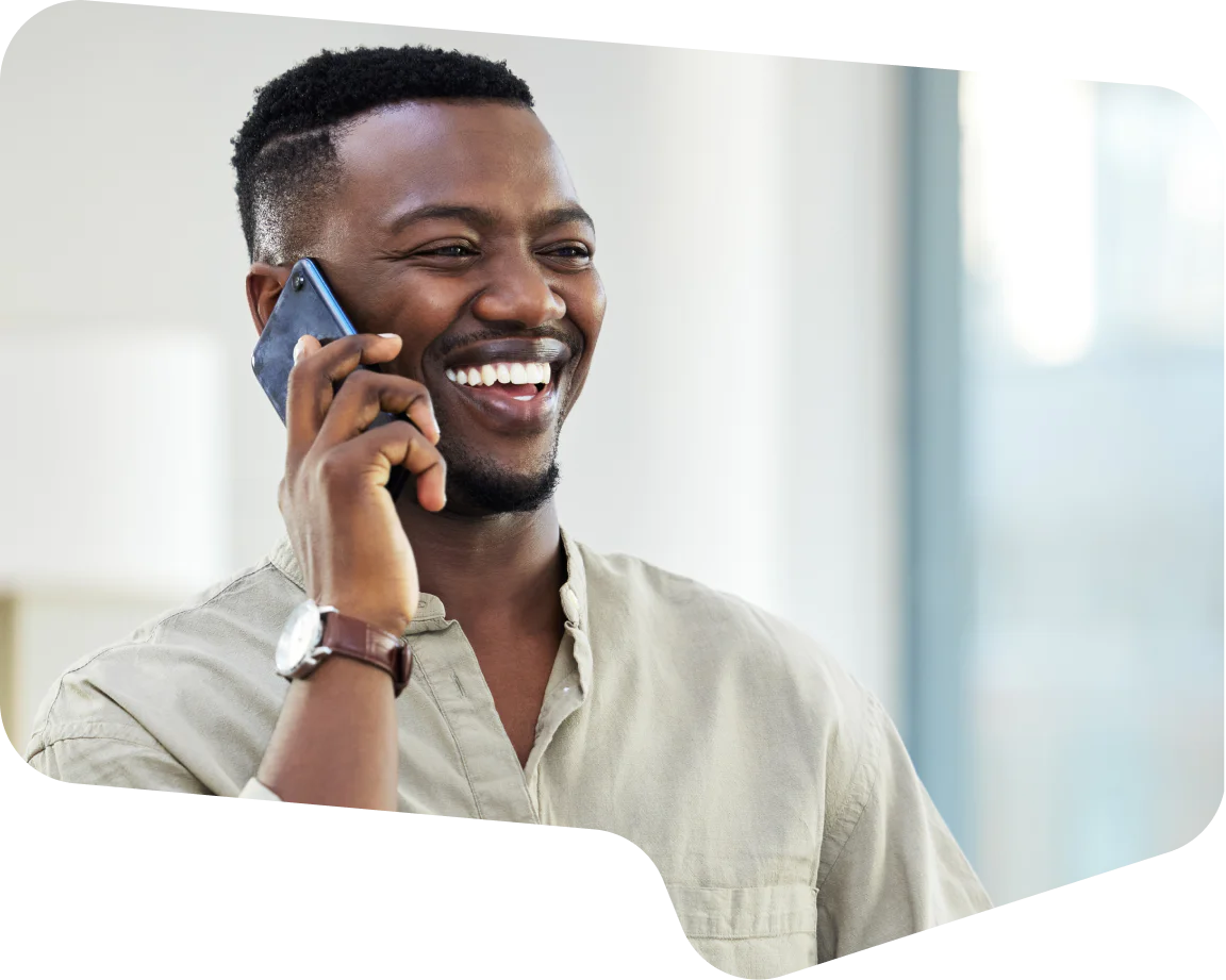 Smiling Man Talking on the Phone Man smiling and making a phone call with a smartphone